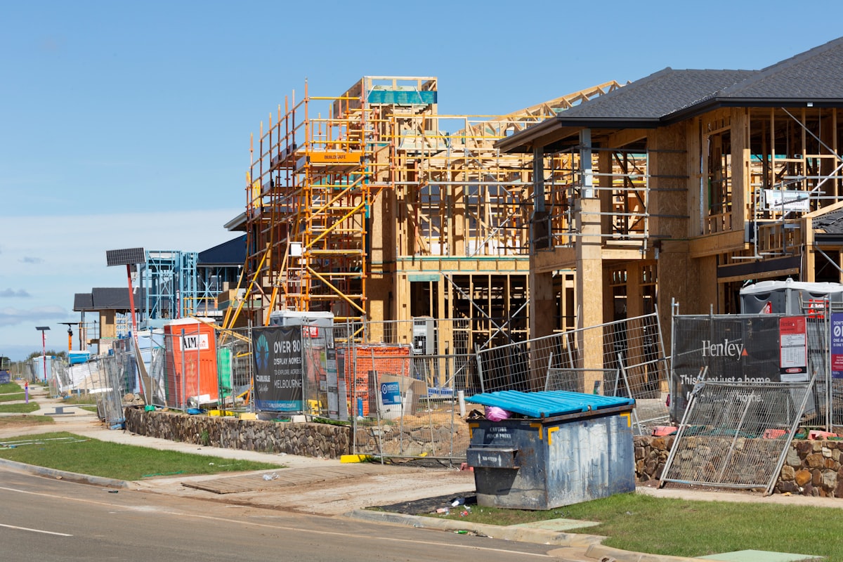 Wood-framed residential construction site showing slowed single-family and multifamily starts relevant to GC bid pipeline.