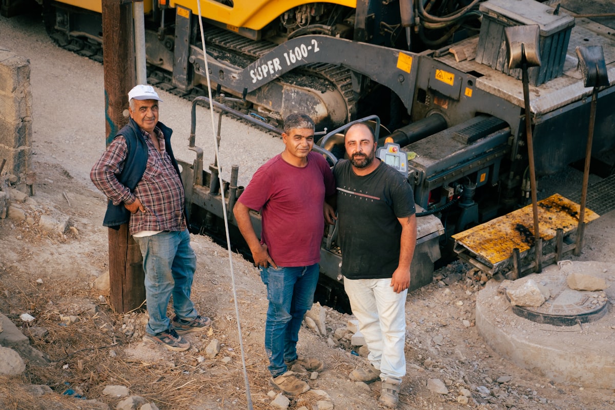 A diverse construction crew on a jobsite, representing the record share of immigrant workers in U.S. construction trades.
