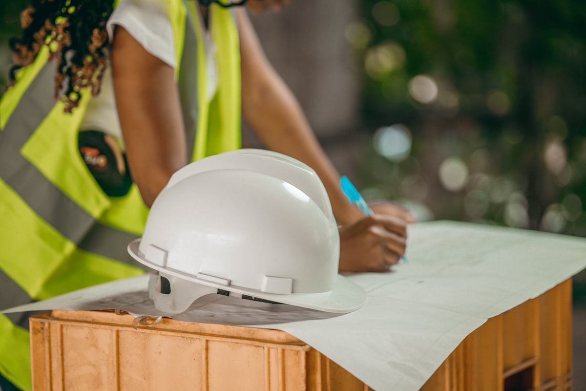 A general contractor project manager coordinating with field crew after a subcontractor abandonment on an active construction site.