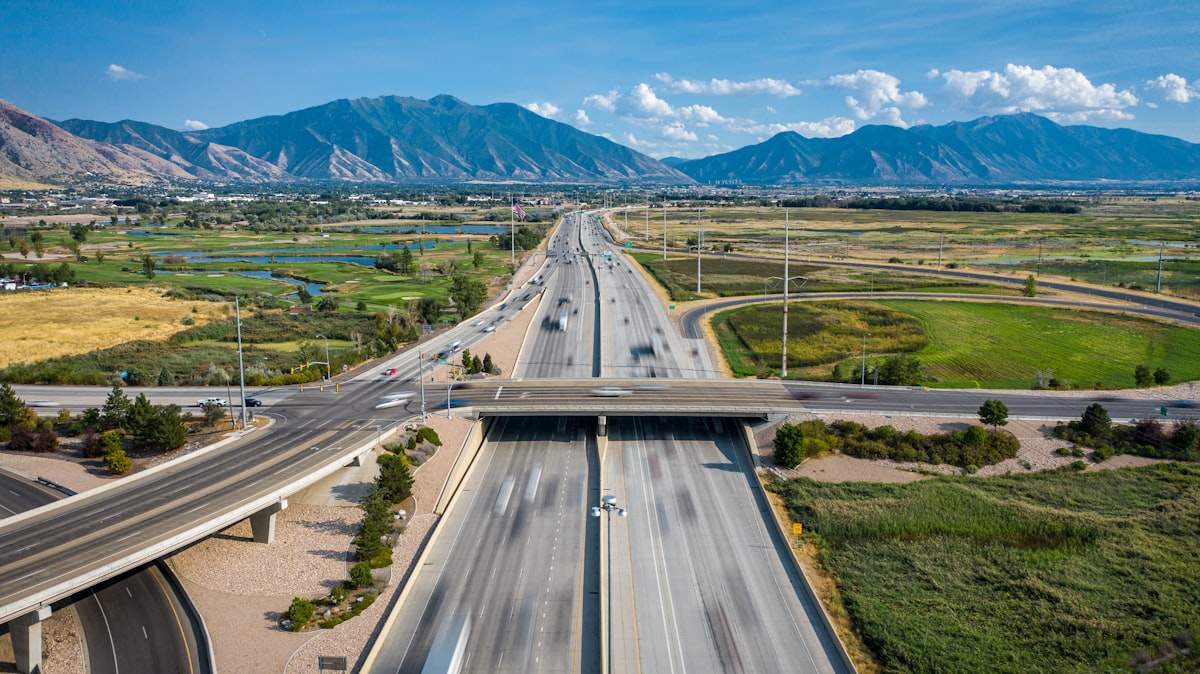 Aerial view of highway construction in a mountain region, representing regional GC market expansion.