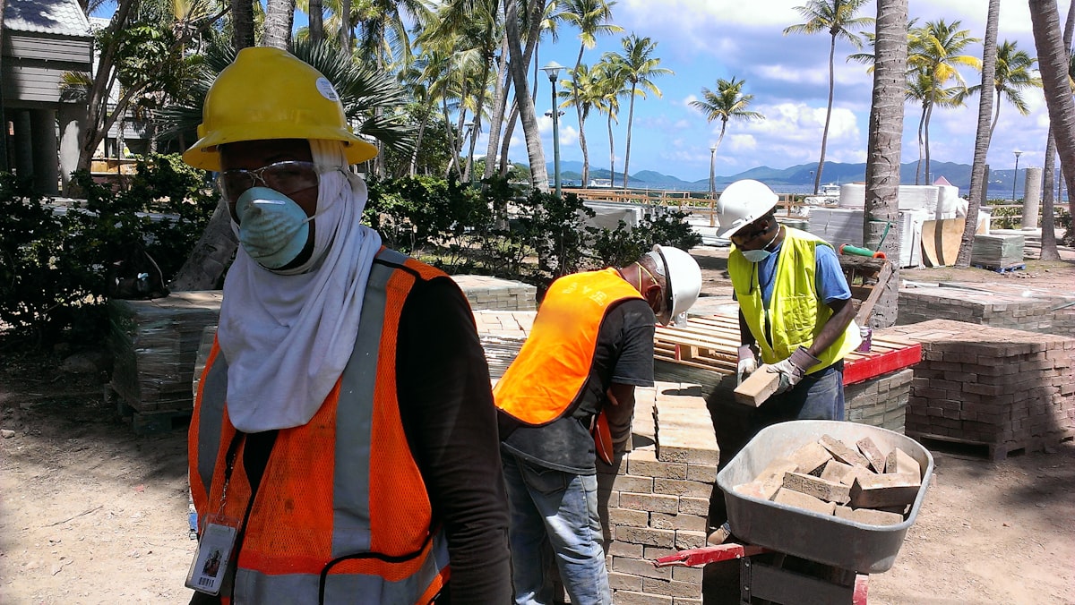 A construction crew on an active job site, representing the skilled labor shortage facing GC estimators trying to secure qualified subcontractors.