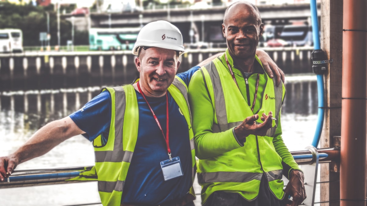 Construction workers taking a break on a job site, representing mental health awareness and safety culture in the trades.