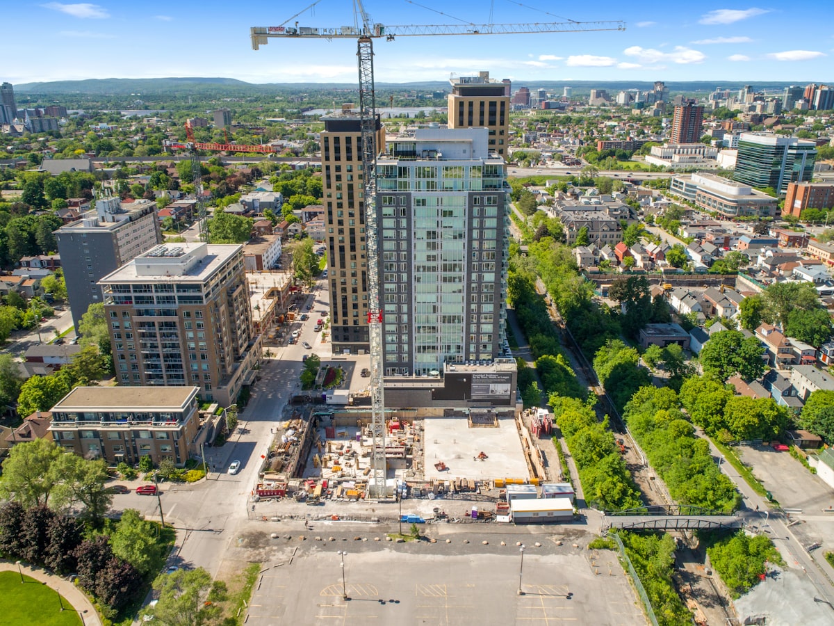 Multifamily building under construction with a crane visible, reflecting the March rebound in residential spending across single-family and multifamily segments.