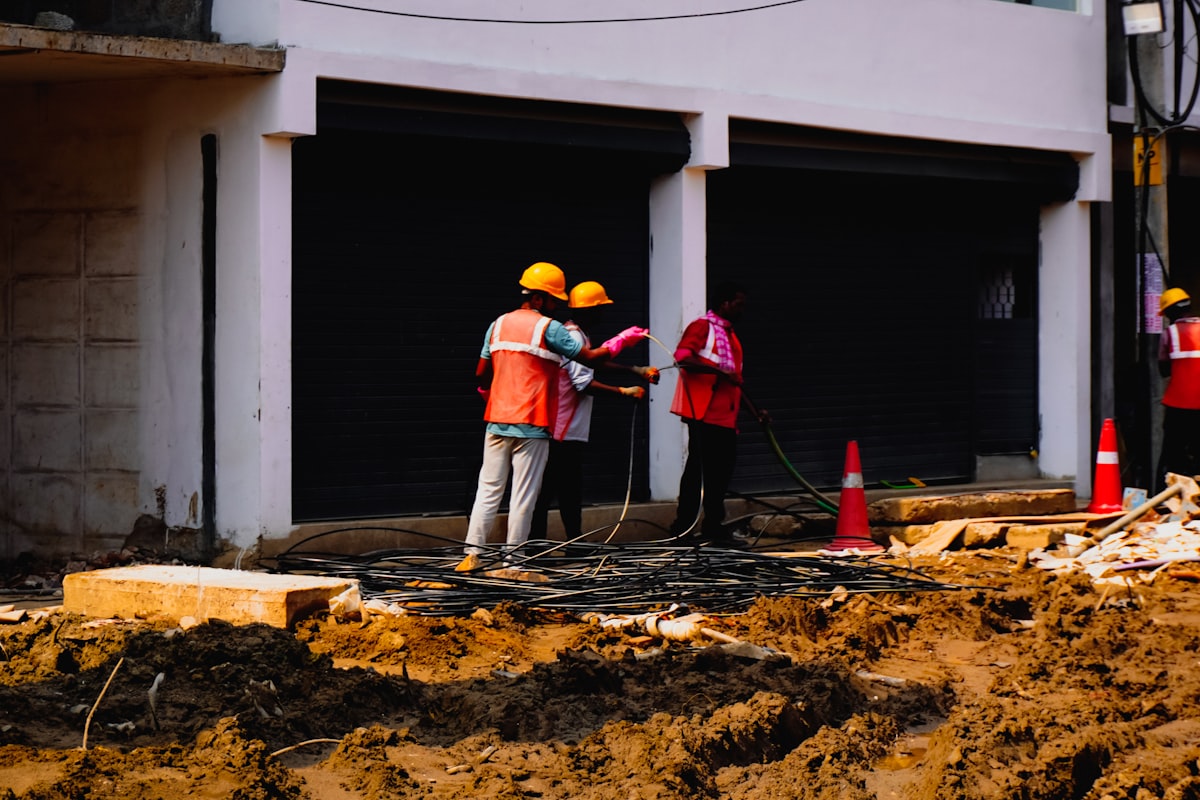 A general contractor and subcontractor meeting on a jobsite to discuss an upcoming project scope.