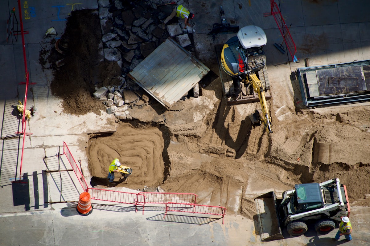 A GC estimator reviewing project data on a tablet at a construction site, reflecting the shift toward subscription-based preconstruction platforms.