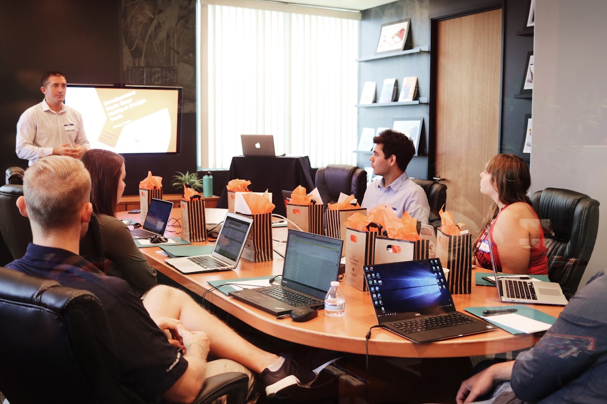 A GC estimator reviewing a project proposal document at a preconstruction meeting.